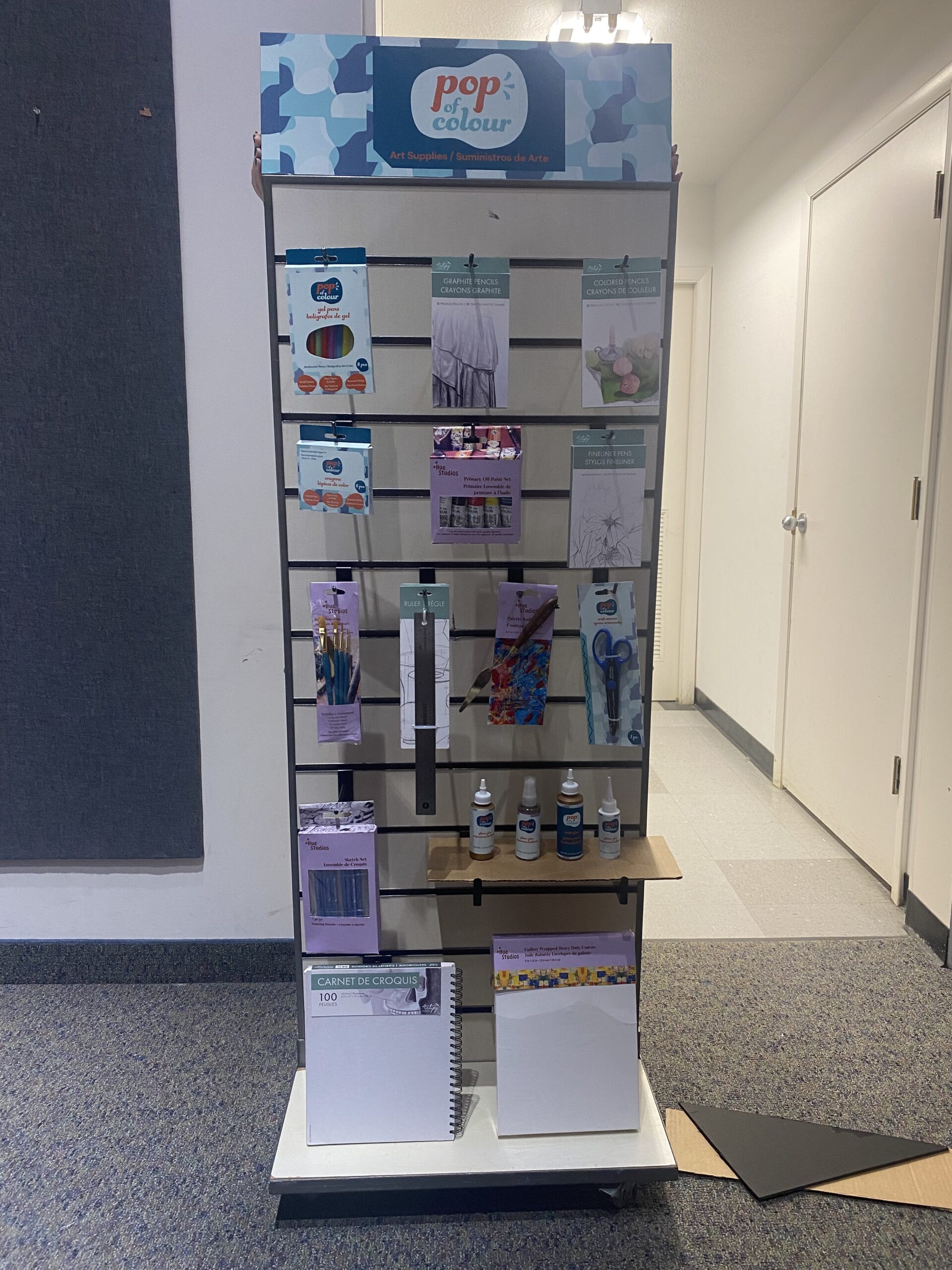 Pop of Colour mockups hung and shelved along with its two competitors' productts